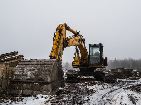 old yellow bulldozer at winter in workplace