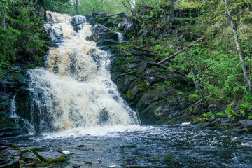 Picturesque landscape with a waterfall in the forest of Karelia