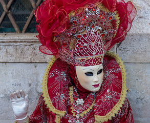 Beautiful red mask and costume at the Venice carnival