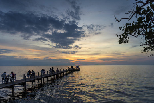 tourists view sunset by pier in kep town cambodia coast
