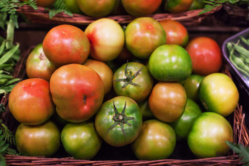 Naklejka na ściany i meble Fresh tomatoes background. Organic Ripe various tomatoes in market. Harvesting concept.