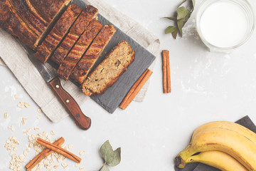 Sliced banana bread with cinnamon on a black slate. Gray background. Vegan Healthy Food Concept. Top view.