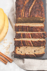 Sliced banana bread with cinnamon on a black slate. Gray background. Vegan Healthy Food Concept. Top view.