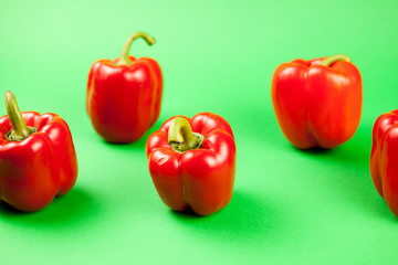 Group of fresh healthy sweet red pepper on green background