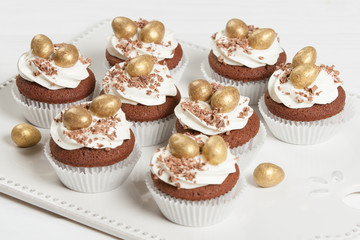 Easter Cupcakes Decorated With Golden Chocolate Eggs. Home Baked.