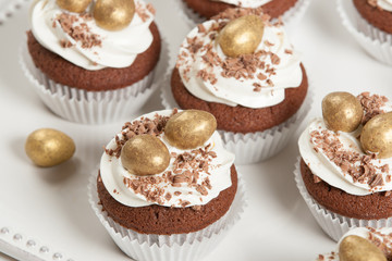 Easter Cupcakes Decorated With Golden Chocolate Eggs. Home Baked.