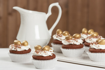 Easter Cupcakes Decorated With Golden Chocolate Eggs. Home Baked.