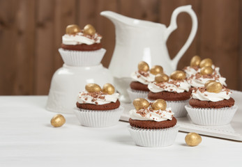 Easter Cupcakes Decorated With Golden Chocolate Eggs. Home Baked.