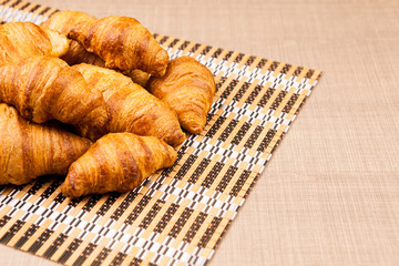 Delicious fresh baked croissants on a table