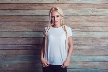 Beautiful girl with two braids in a white T-shirt. Mock-up.