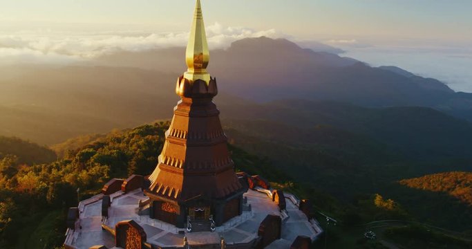 Cinematic aerial view of Buddhist temple at sunrise
