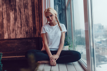 Beautiful girl with two braids in a white T-shirt. Mock-up.