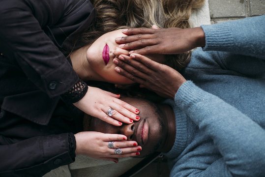 Deep connection between two young people of different races. They cover your eyes - Powered by Adobe