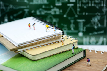 Miniature people : children with book and school background. Back to school concept
