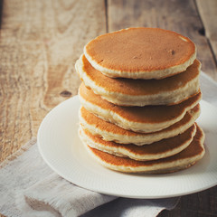 Pancakes day background, stack of homemade pancake over wooden table
