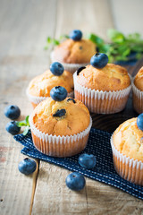 Blueberries muffins or cupcakes with mint leaves