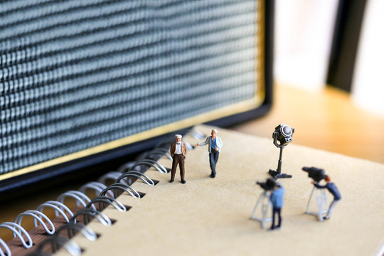 Miniature people : the small team of tv reporter of Audio Speakers, production television concept.