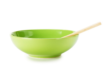 green empty ceramic bowl and wooden spoon  isolated on white background
