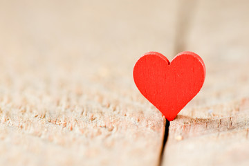 Fototapeta premium Heart on a wooden background. Background in the style of Valentine's Day. Heart on a wooden background