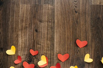 Valentine 's Day background, red and yellow hearts on wood texture