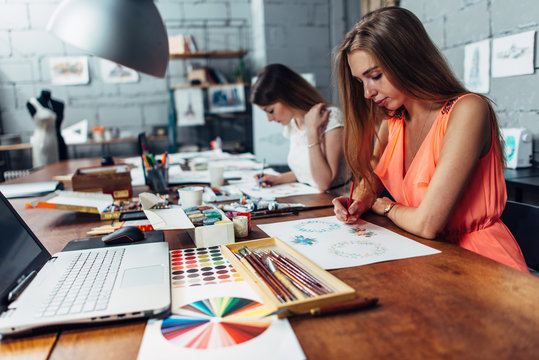 Group of creative fashion designers drawing sketches of accessories working in studio