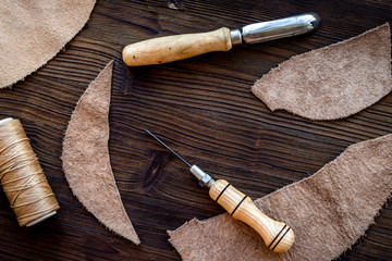 Tanner's workplace. Tools and matherials on dark wooden backgrou