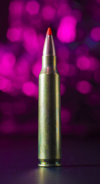 AR 15 ammunition with a pink background