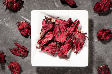 Chinese herbal medicines -- Roselle in white plate on stone background
