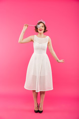 Full length portrait of a happy girl wearing crown