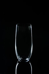 one glass on black reflecting table