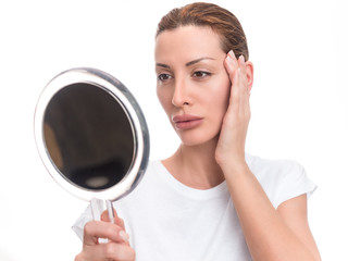 Woman Looking At Herself In The Mirror.