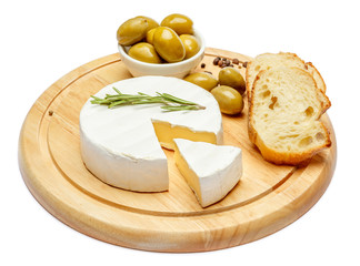 Round brie or camambert cheese on cutting board white background