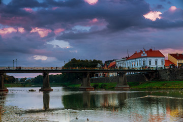 Fototapeta na wymiar Evening pedestrian bridge in the center of Uzhgorod in the sunset Ukraine