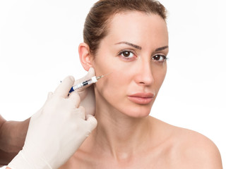 Closeup of beautiful woman receiving hyaluronic acid treatment. Isolated over white background.