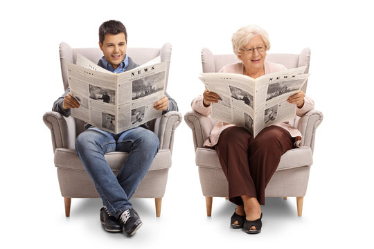 Young man and an elderly woman sitting in armchairs and reading newspapers