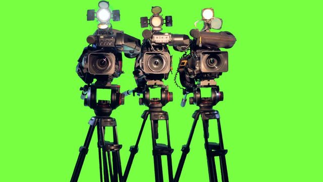 Professional broadcast studio video cameras on green screen.
