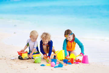 Fototapeta na wymiar Kids on tropical beach. Children playing at sea.