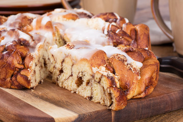 Sliced Glazed Streusel Coffee Cake on a Wooden Board