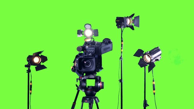 Professional broadcast studio video camera and spotlights.