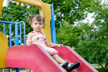 Fototapeta na wymiar Cute little girl on a playground.