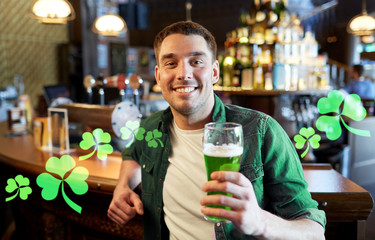 man drinking green beer at bar or pub