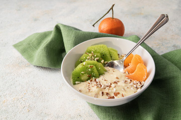 healthy breakfast from quark or curd cheese, linseed oil with omega 3 fatty acids, fresh kiwi,...
