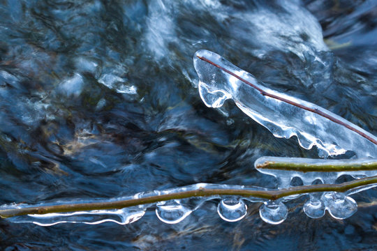 Big icicles at a river in winter