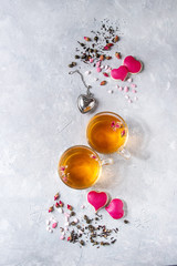 Love Valentines day greeting card with two glasses of hot tea, rose buds, heart shape homemade...