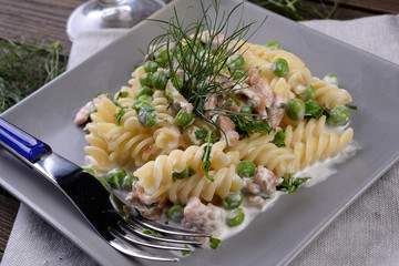 Plate of pasta fusilli with peas and salmon cream