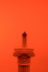orange toned picture of aerosol paint in can on column