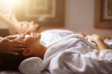 Keuken spatwand met foto happy young beautiful couple enjoying head massage at the spa © alfa27