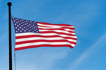 Obraz premium US Flag waving over blue sky (digitally generated image)