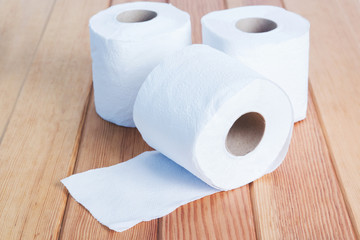 White toilet tissue roll on wood.