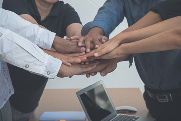 Fototapeta premium business working team put hand together for fighting; working team building